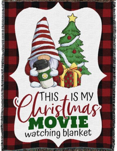 A decorative blanket featuring a gnome holding a coffee cup next to a Christmas tree and gift, with the text This is my Christmas movie watching blanket.