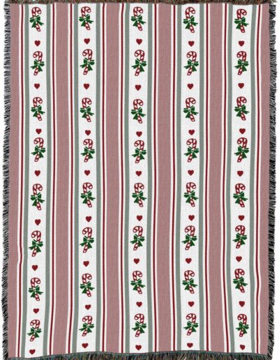 Woven throw blanket with a pattern of vertical stripes, candy canes, and small red hearts.